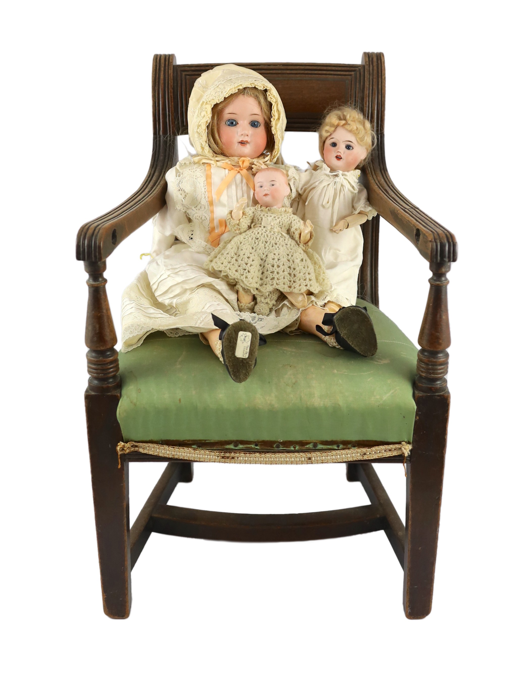 A Max Oscar Arnold bisque doll, German, circa 1920, 11.5in. (3) Please note the chair is for display purposes only.